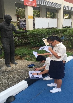 Sec 2 student examining school monument.jpg